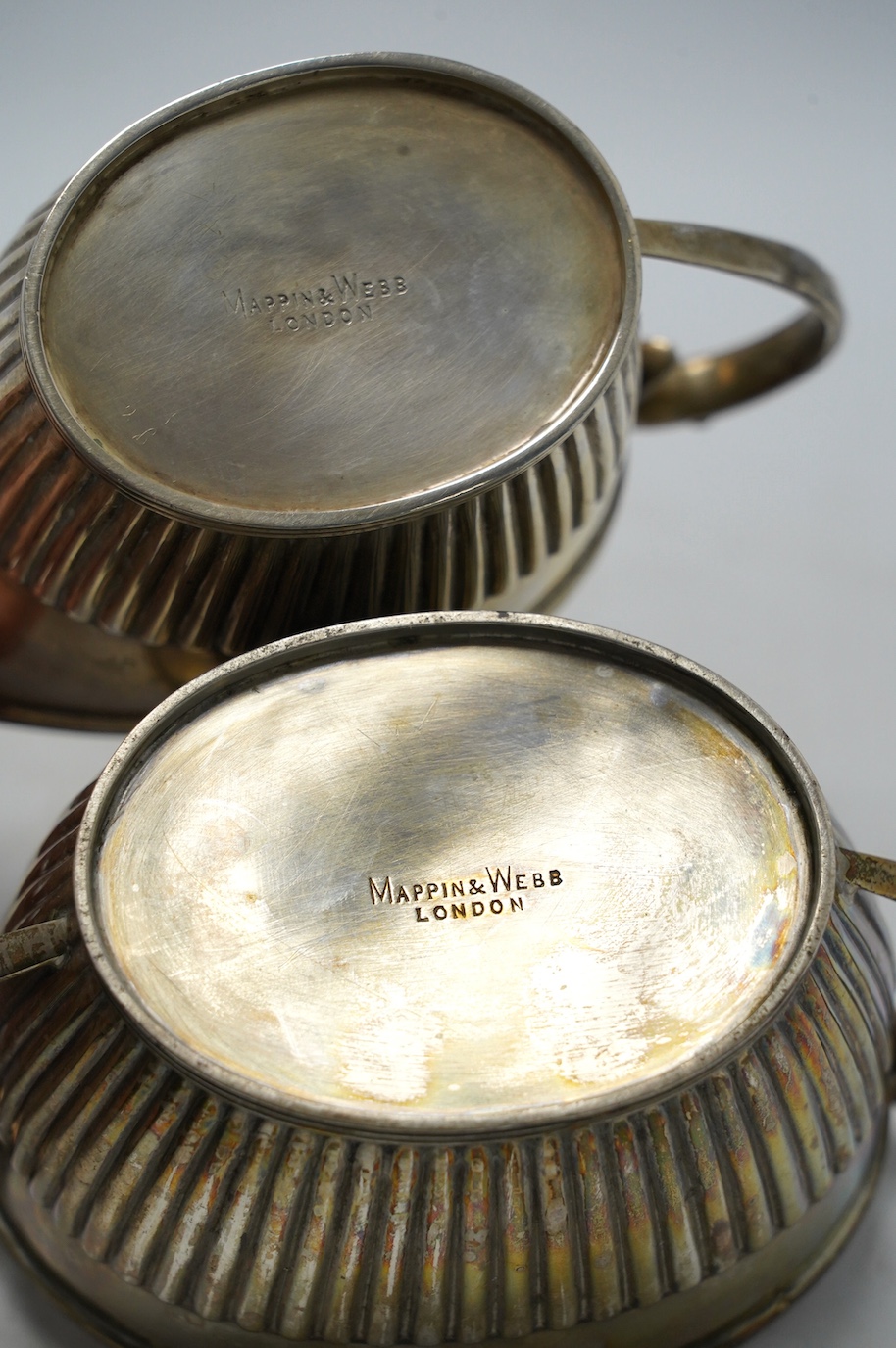A late Victorian demi-fluted sugar bowl and cream jug, by Mappin & Webb, Sheffield, 1894, 8.6oz. Condition - fair